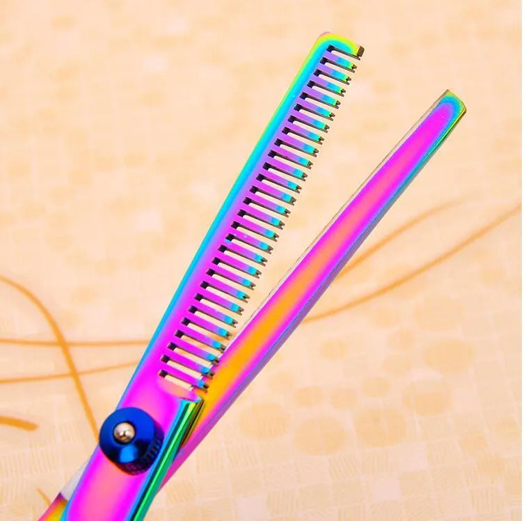 Three pet grooming scissors with purple handles on white background including curved flat and tooth shears