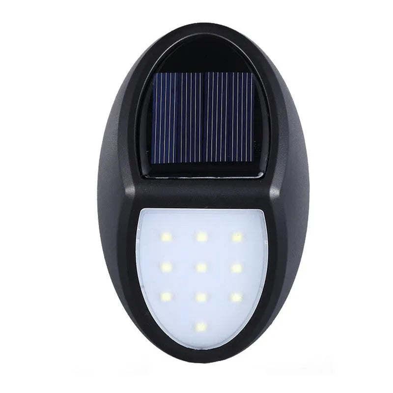 Black rectangular LED solar wall light with solar panel, shown mounted on an outdoor wall.