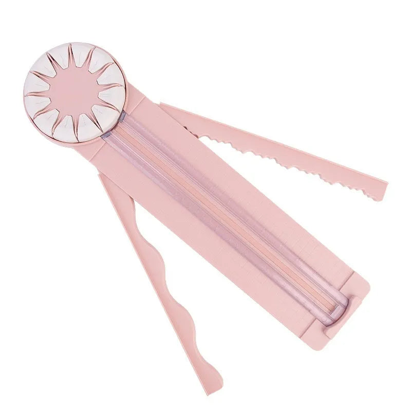 Pink and black 12-in-1 manual plastic paper cutting machine on a white background.