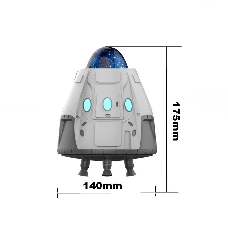 White space capsule shaped Bluetooth Northern Lights ambience light with remote control on a dark surface.