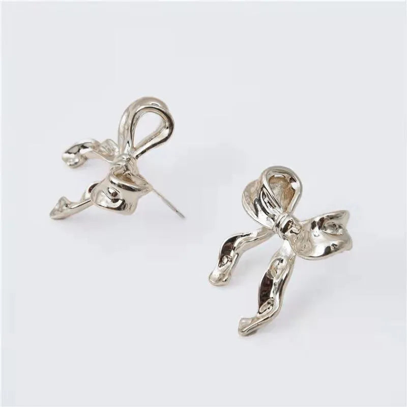Pair of bow earrings in simple style, alloy with electroplated gold or silver finish