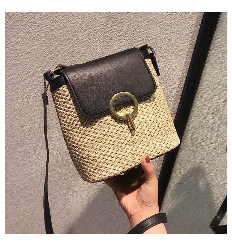 Women's straw woven bucket shoulder bag in black with cover flap, small size, polyester lining