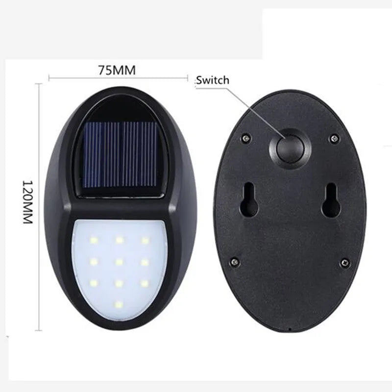 Black rectangular LED solar wall light with solar panel, shown mounted on an outdoor wall.