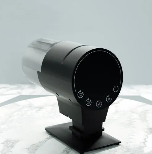 Black plastic automatic aquarium fish feeder with 210ml silo and timer control on tank rim