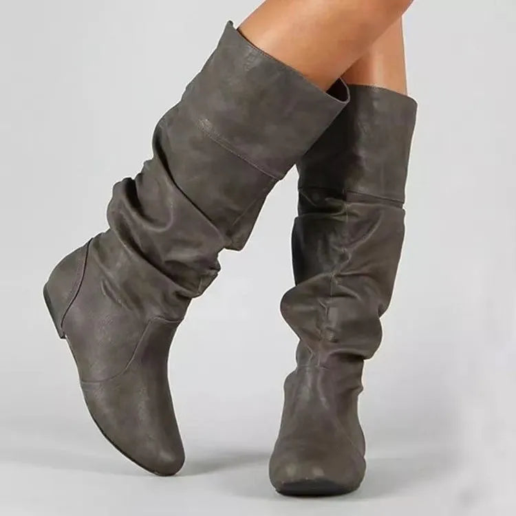Women's flat round toe slip-on ankle boots in black PU leather with a high shaft and rubber sole.