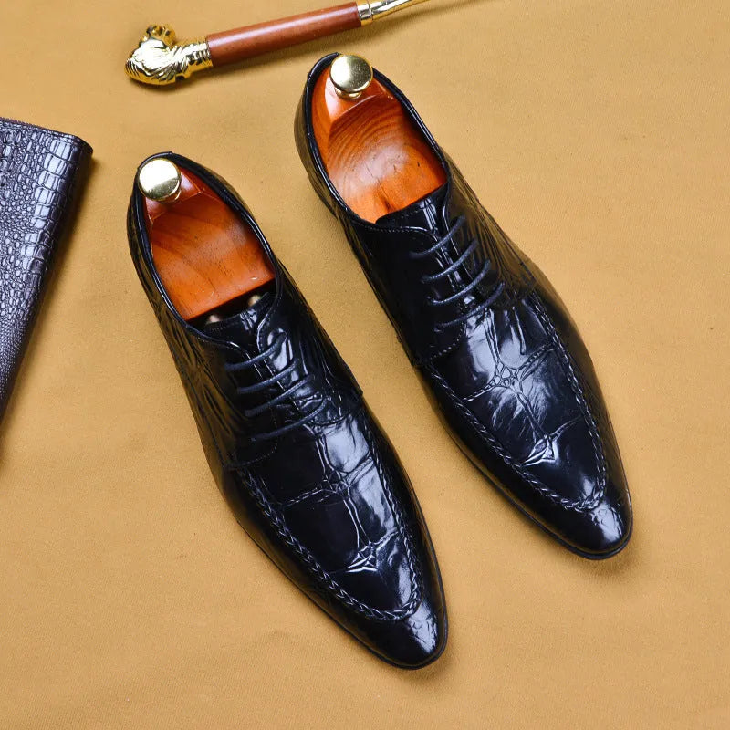 Men's black leather shoes with alligator pattern texture and a silver horse bit buckle on the front.