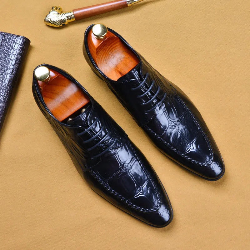 Men's black leather shoes with alligator pattern texture and a silver horse bit buckle on the front.