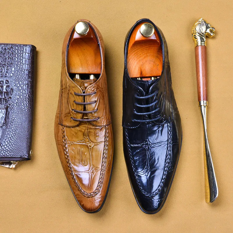 Men's black leather shoes with alligator pattern texture and a silver horse bit buckle on the front.