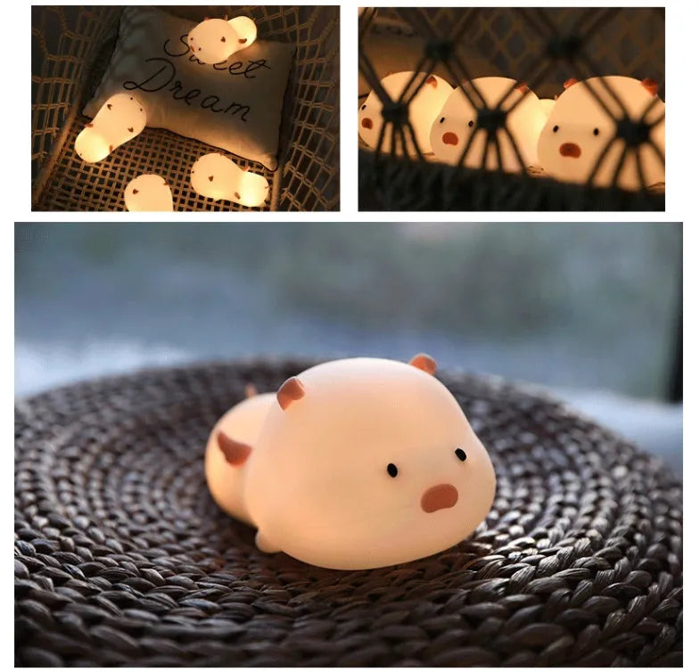 Pink silicone pig-shaped night light with touch control on bedside table