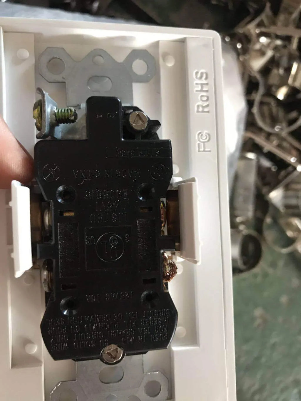 White socket induction night light plugged into wall outlet with automatic light sensor.