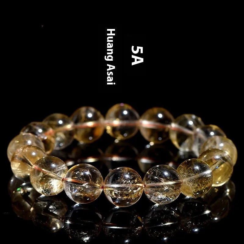 Natural yellow citrine gemstone bracelet with geometric beads on white background