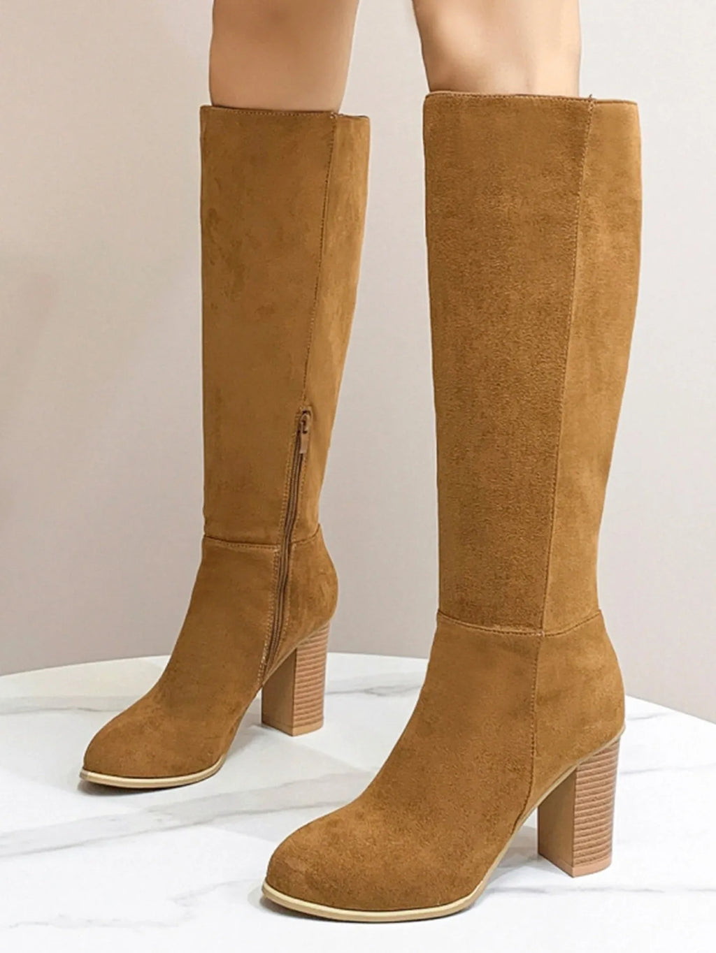 Black women's square toe high heel fashion boots made from artificial PU material.