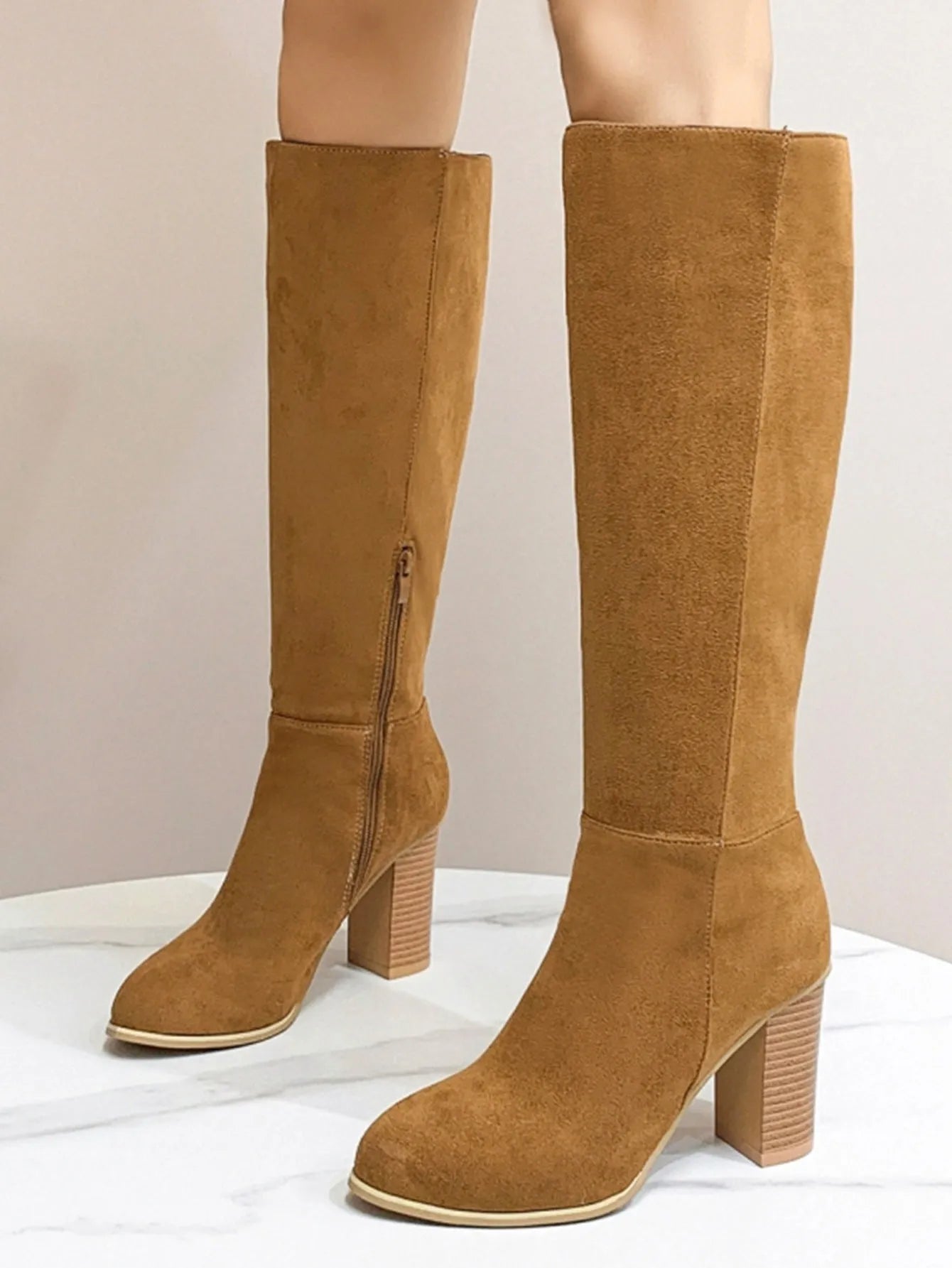 Black women's square toe high heel fashion boots made from artificial PU material.
