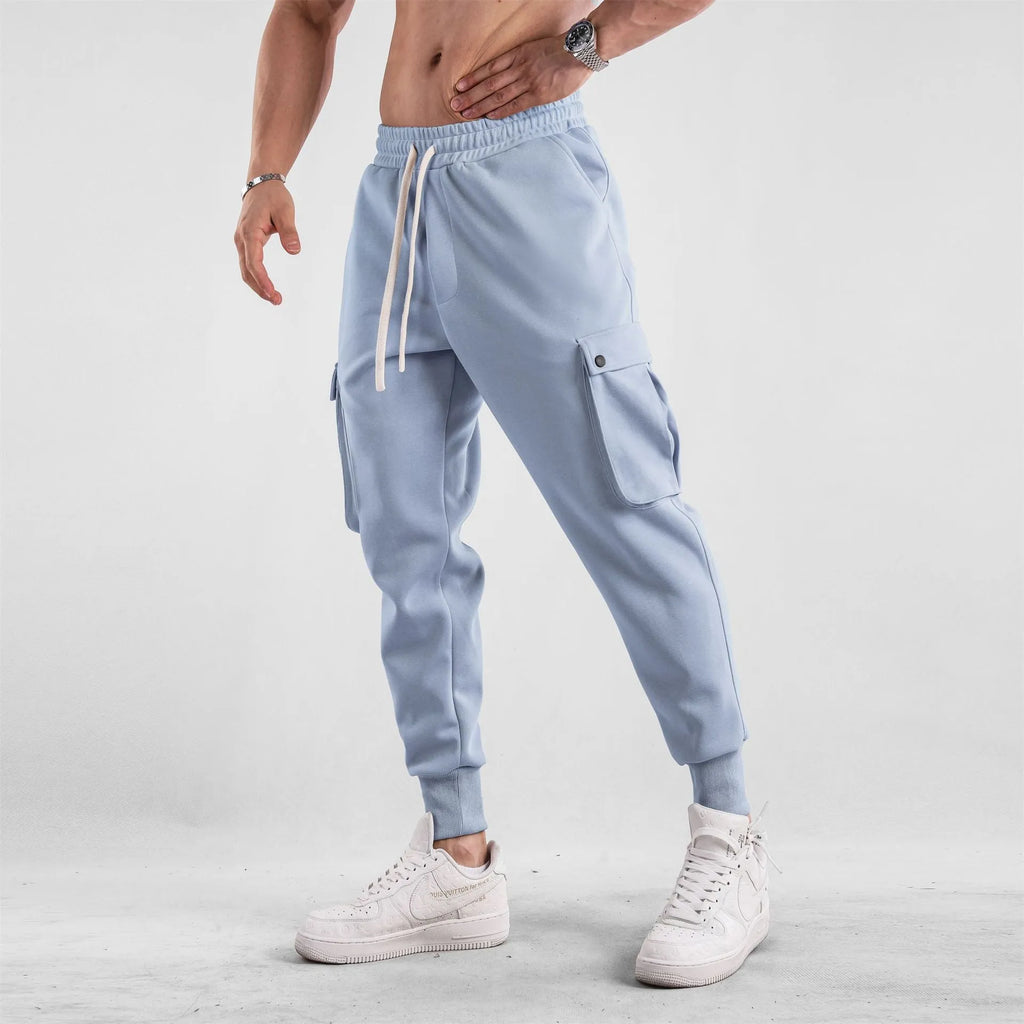 Men's loose fit cotton sports trousers with ankle ties in apricot colour showing multiple pockets