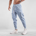 Men's loose fit cotton sports trousers with ankle ties in apricot colour showing multiple pockets