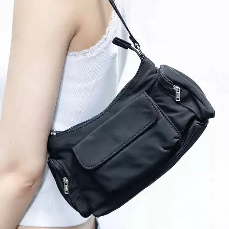 Black lightweight women's shoulder bag with double pockets showing side line detailing