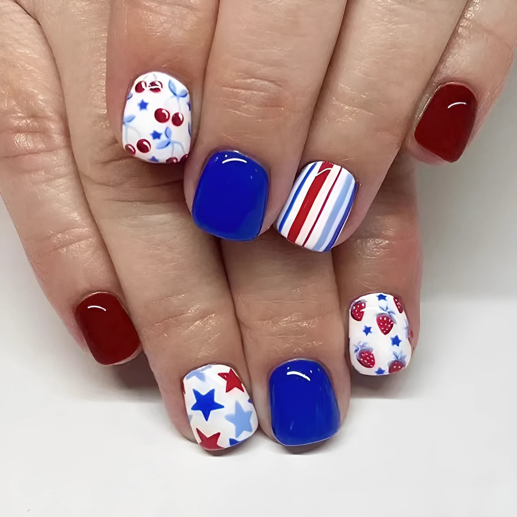 Glossy red and blue strawberry cherry independence day nail stickers, short style.