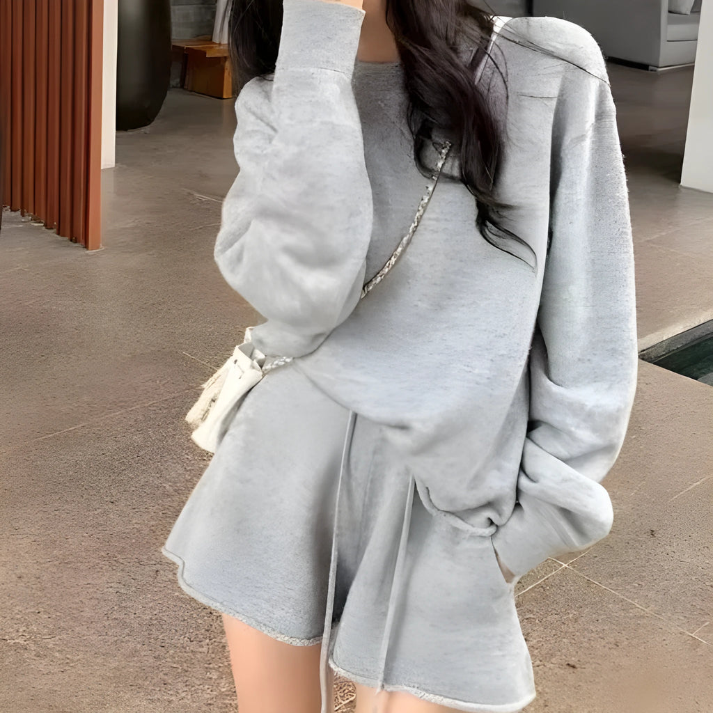 Women's knitted two-piece set showing loose-fitting long sleeve sweater and matching wide-leg shorts in neutral colour