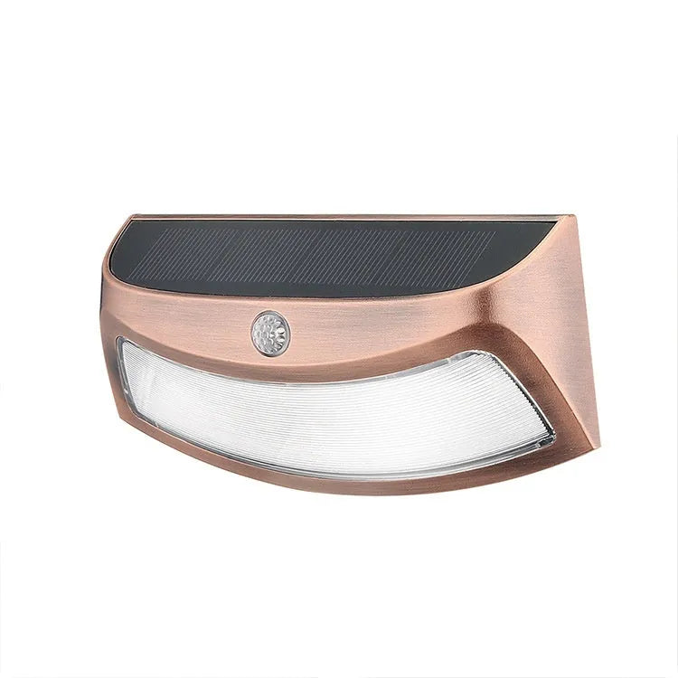 Solar-powered outdoor wall lamp with smiling face design for garden lighting