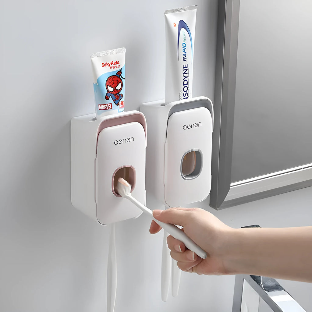 Automatic toothpaste dispenser wall mounted unit in blue, grey or pink colours with no-drip nozzle