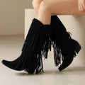 Women's brown suede knee-high boots with tassels and a chunky waterproof platform sole.