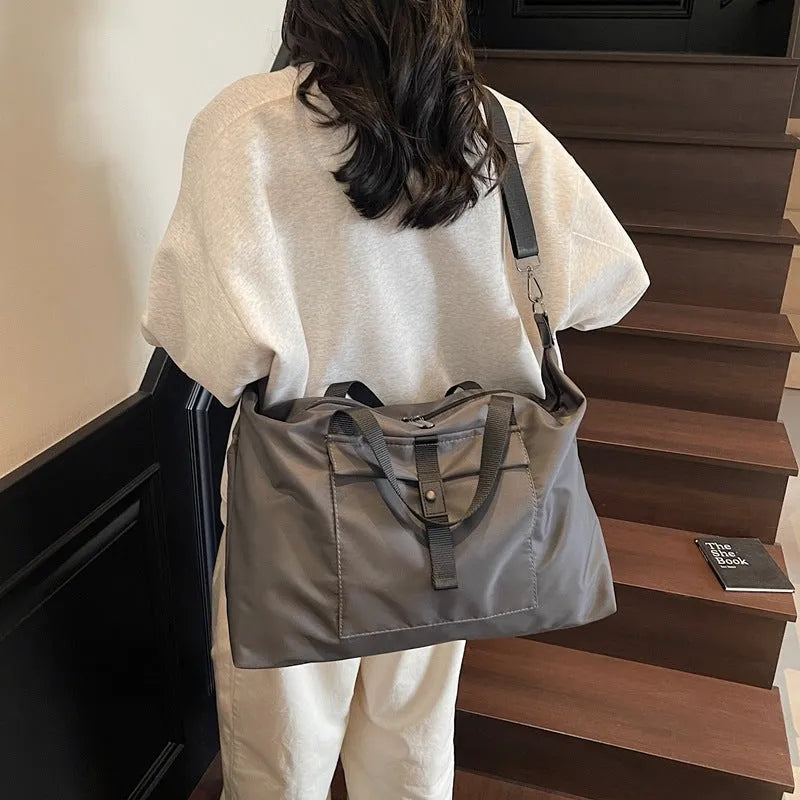 Grey one-shoulder travel bag with large 36-55 litre capacity and Oxford cloth construction