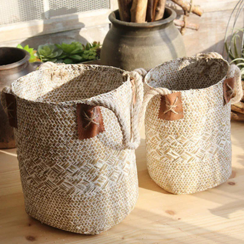 Hand woven seagrass basket in brown, size L, on a wooden surface