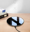 Black QI wireless charging pad with smooth surface and silicone non-slip base for 15W fast charging