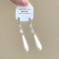 Geometric heart shaped women's ear clips with rhinestone stars and dangling tassel details
