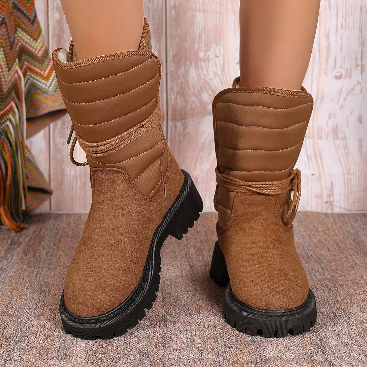 Women's black chunky heel snow boots with lace-up front and fleece lining.