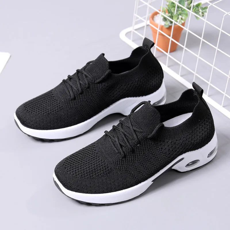 Women's black mesh casual sneakers with lace-up front and round toe on a soft PVC sole.