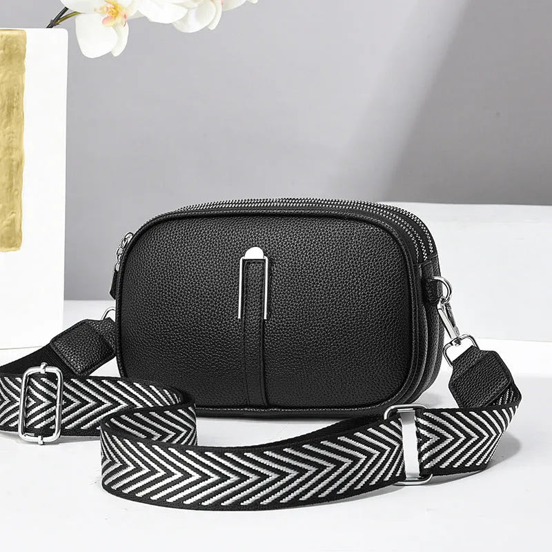 Women's soft PU crossbody bag in oval shape with interior organisation compartments