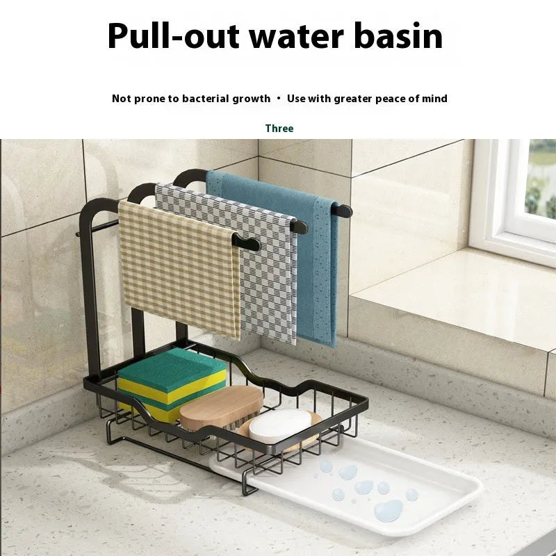 Foldable white plastic kitchen rack for wall mounting or desktop use, holding a sponge and cloth.
