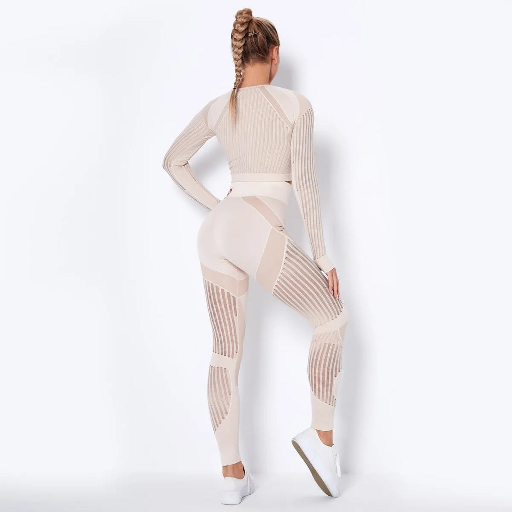 Woman wearing a seamless long-sleeved yoga suit in a neutral colour, demonstrating a stretch pose.