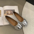 Women's black split-toe flat pumps with a round toe and slip-on oversleeve design.