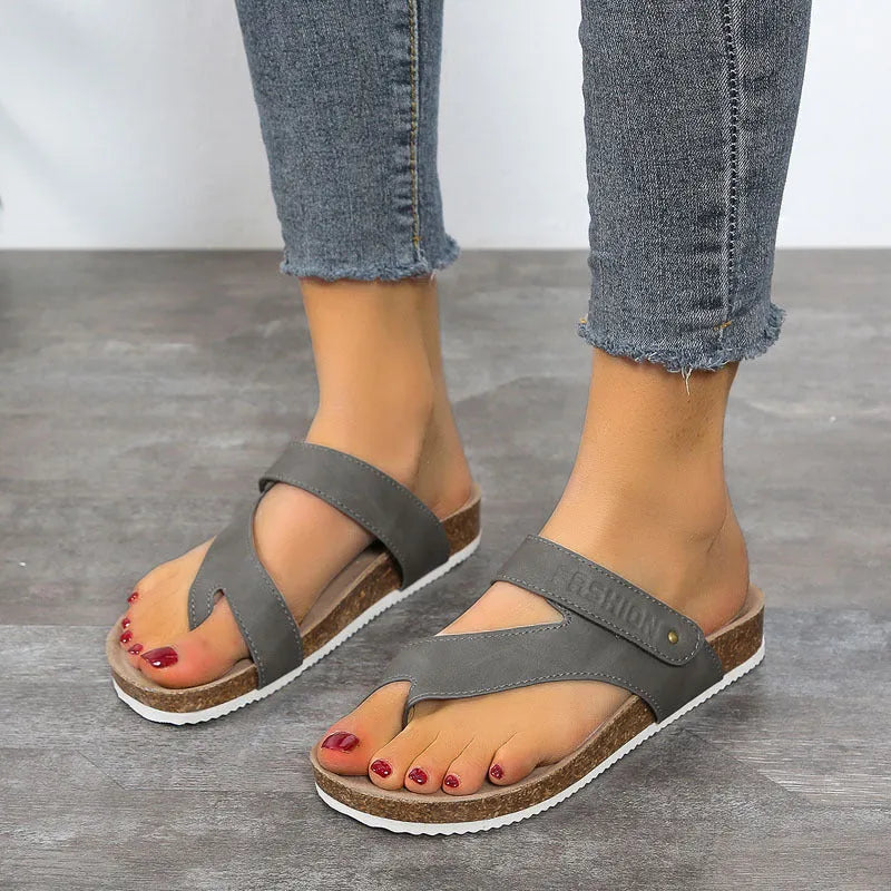 Women's flat toe ring flip-flops in blue with a thick foam sole, shown from the side.