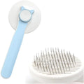 Blue self-cleaning cat brush with rubber-tipped pins and a one-click button on the handle