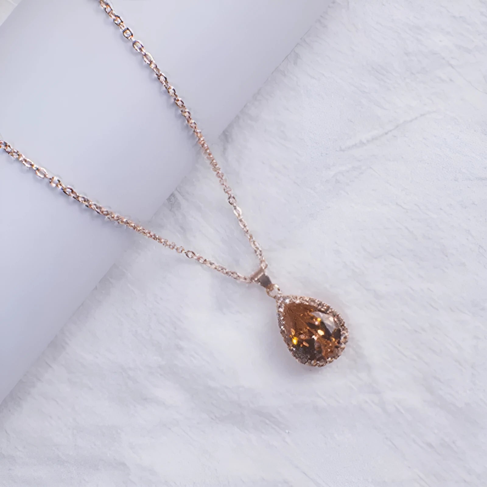Rose gold water drop necklace with geometric rhinestones in pink colour