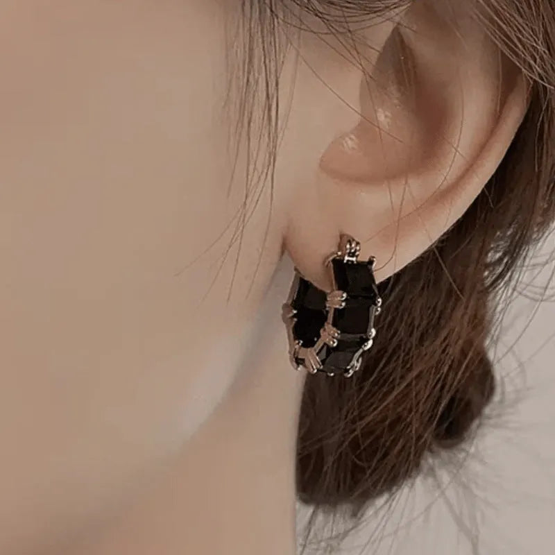 Geometric U-shaped gold ear ring with round black zircon stones