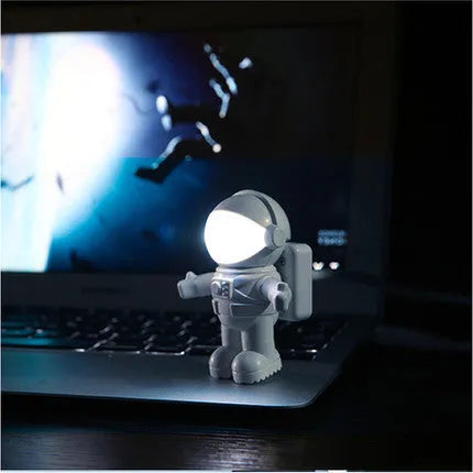 Astronaut USB LED desk lamp with flexible gooseneck and helmet switch on a desk