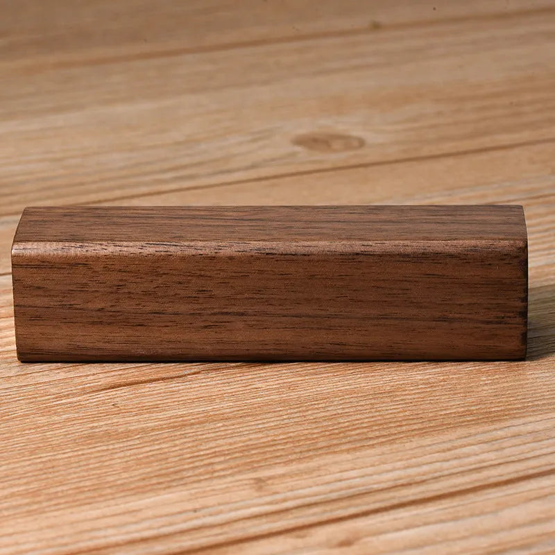 Portable power bank with brown walnut wood shell showing charging ports