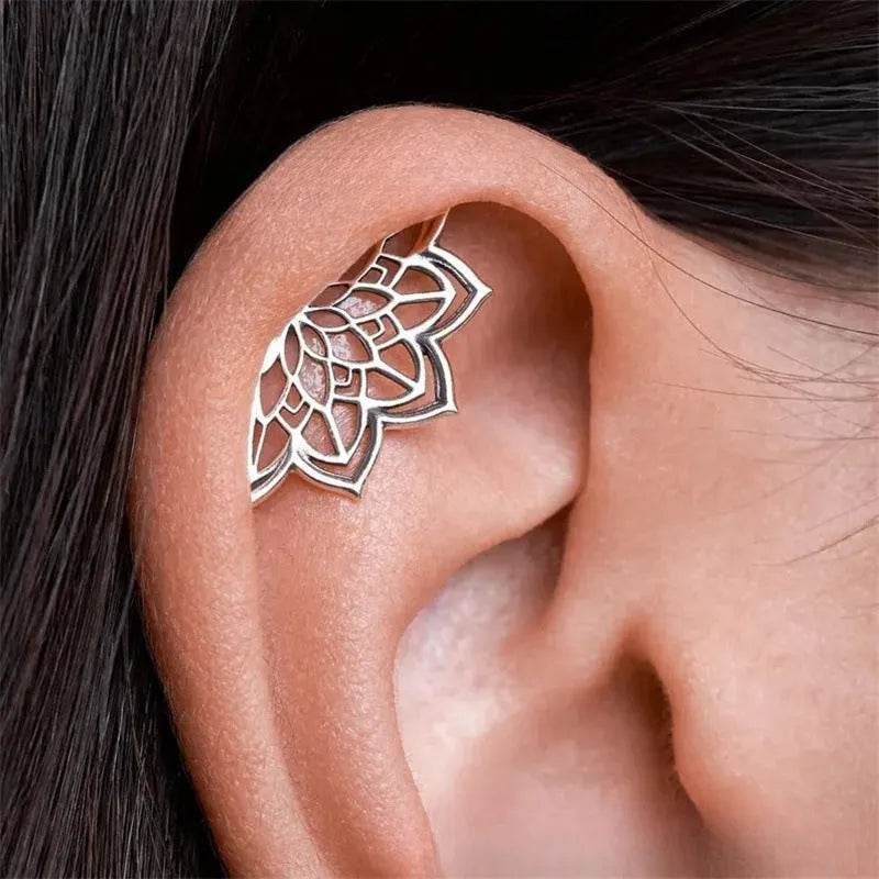 Spider web geometric mesh design stud earrings in gold and silver electroplated finishes.