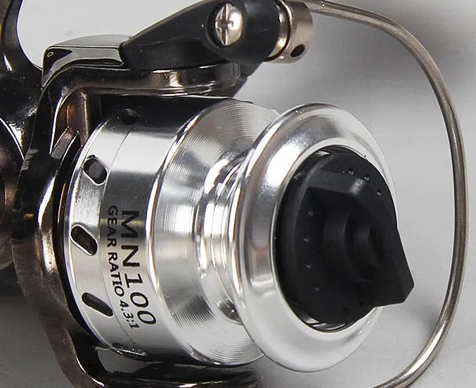 Mini 100 all metal fishing reel in black, 8cm high, with wooden handle rocker arm folded
