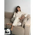 Women's white floral print lounge suit with bell sleeve top and wide-leg trousers
