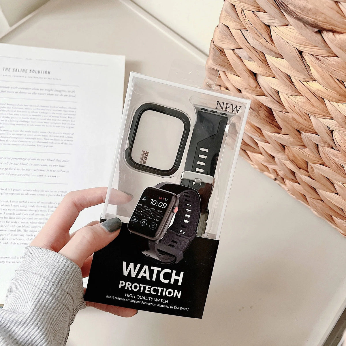 Two-tone silicone protective case for Apple Watch in black and white, fitted on a watch face