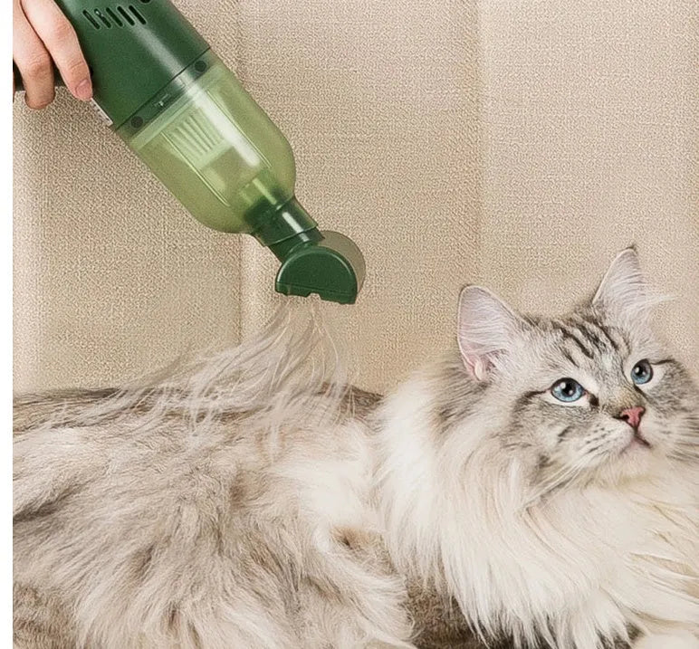 Electric cat and dog hair suction cleaner in green, USB powered, 244x72x157mm, with two suction heads on a fabric surface.