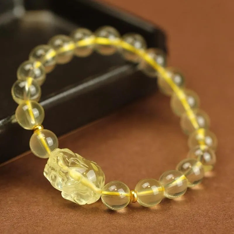 Yellow leather bracelet with a citrine crystal Pi Xiu charm in Chinese national style.