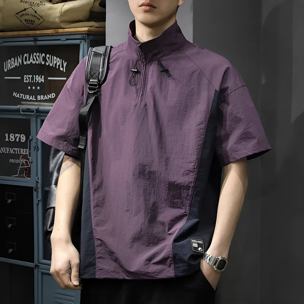 A brown men's loose-fit short-sleeve shirt with a half-zip front and stand collar.