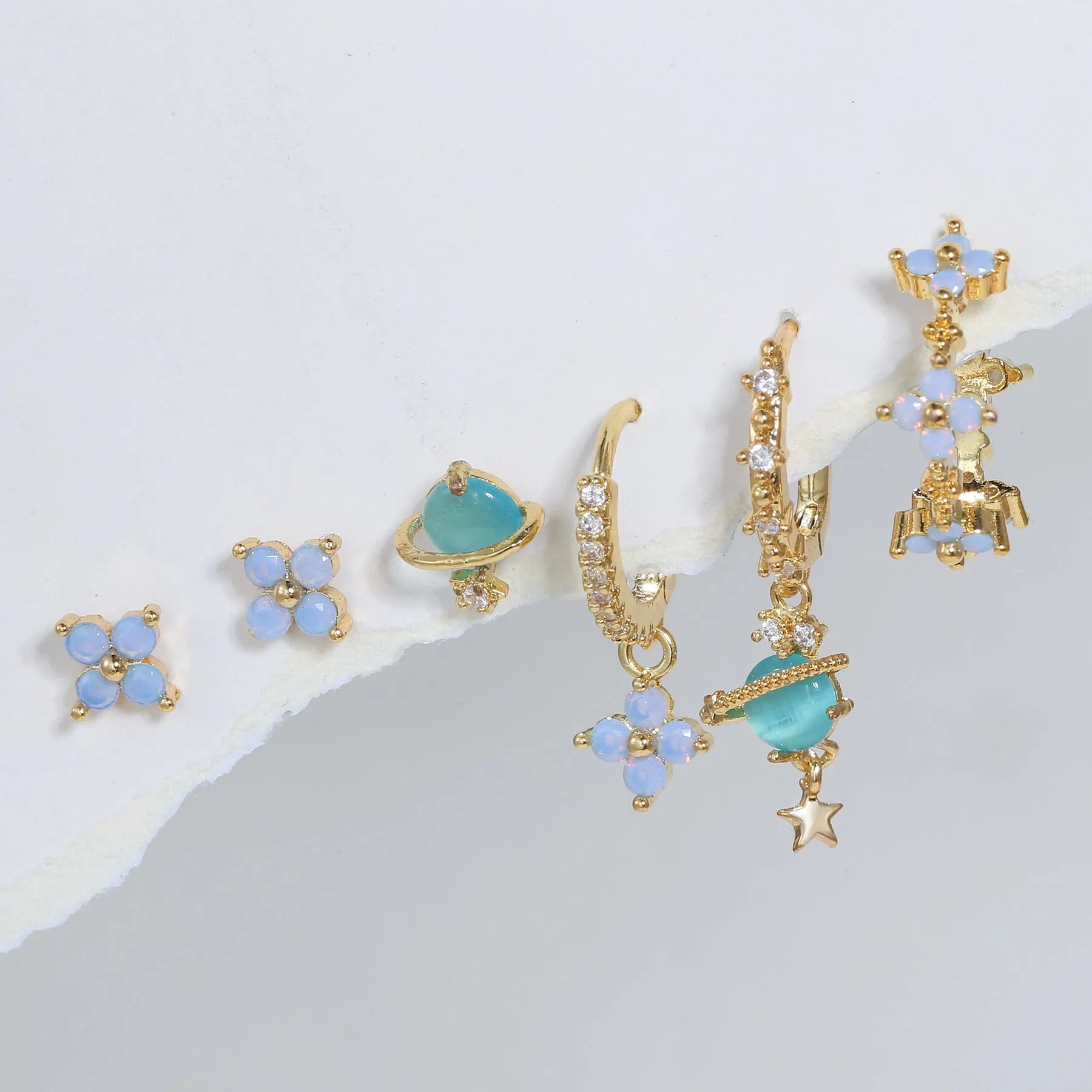 Gold and silver flower-shaped ear studs with zircon mosaic accents in Japanese Korean style