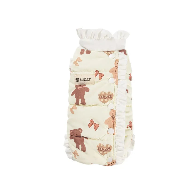 Small dog wearing cream fleece jumpsuit with bear pattern and white ruffles